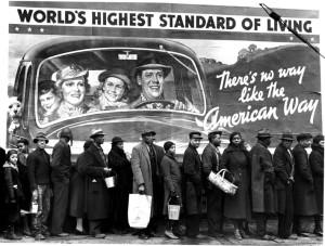 African American flood victims lined up to get food & clothing fr. Red Cross relief station in front of billboard extolling WORLD'S HIGHEST STANDARD OF   LIVING/ THERE'S NO WAY LIKE THE AMERICAN WAY. City: LOUISVILLE State: KY Country: US Photographer: MARGARET BOURKE-WHITE/TimePix