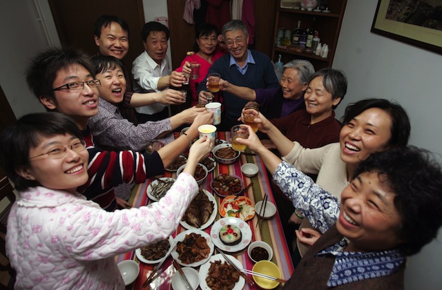 BEIJING, CHINA - FEBRUARY 17: (CHINA OUT) Members of a family toast during New Year's Eve dinner at a resident's home on February 17, 2007 in Beijing, China. The Chinese lunar New Year, or the Spring Festival, falls on February 18. (Photo by China Photos/Getty Images)