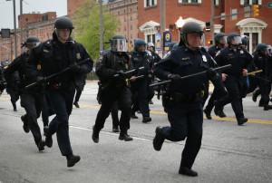 BALTIMORE, MD - APRIL 25: Police in riot gear charge as they try to push protesters away during a march in honor of Freddie Gray on April 25, 2015 in Baltimore, Maryland. Gray, 25, was arrested for possessing a switch blade knife outside the Gilmor Homes housing project on Baltimore's west side on April 12. According to his attorney, Gray died a week later in the hospital from a severe spinal cord injury he received while in police custody. (Photo by Alex Wong/Getty Images)