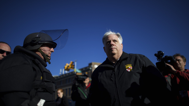BALTIMORE, MD - APRIL 28: Maryland Governor Larry Hogan greets Baltimore police dressed in riot gear the morning after citywide riots following the funeral of Freddie Gray, on April 28, 2015 in Baltimore, Maryland. Gray, 25, was arrested for possessing a switch blade knife April 12 outside the Gilmor Houses housing project on Baltimore's west side. According to his attorney, Gray died a week later in the hospital from a severe spinal cord injury he received while in police custody. (Photo by Mark Makela/Getty Images)